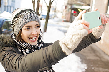 Woman in street taking selfie, Brooklyn, New York,USA