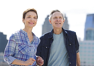 Smiling senior couple walking in city