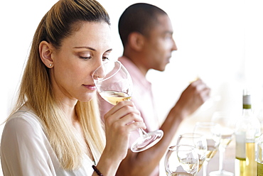 Man and woman tasting white wine