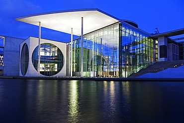 Riverfront parliament office building illuminated at dusk, Germany, Berlin, Federal Parliament Offices