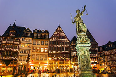 Statue on illuminated square, Germany, Hesse, Frankfurt, Romerberg Plaza