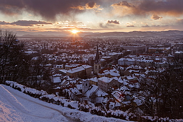 Winter cityscape at sunrise, Slovenia, Ljubljana, St. Florian's Church, St. James's Parish Church