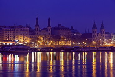 Illuminated waterfront and reflections in river, Hungary, Budapest, Budapest Churches