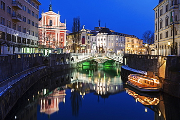 Illuminated buildings and Ljubljanica River, Slovenia, Ljubljana, Franciscan Church