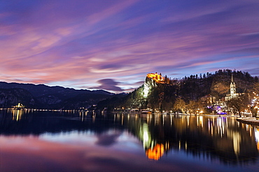 Lake Bled and illuminated Church of the Assumption reflecting in lake, Slovenia, Bled