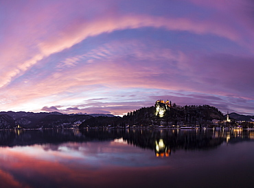 Clouds over Lake Bled and illuminated Church of the Assumption, Slovenia, Bled