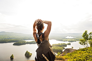 Rear view of young woman looking at lake, USA, Maine, Camden