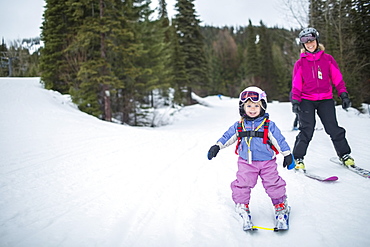 Little girl (2-3) learning skiing with mother, USA, Montana, Whitefish
