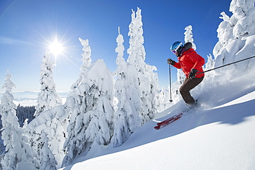 Mature woman on ski slope at sunlight, USA, Montana, Whitefish