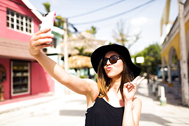 Woman photographing self, Dominican Republic