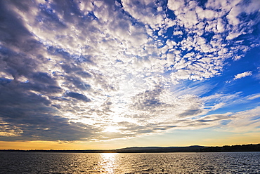 Cloudy sky above bay at sunset, USA, Maine, Rockland