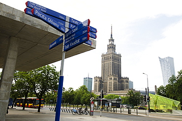 Sign post with Palace of Culture and Science in background, Poland, Warsaw