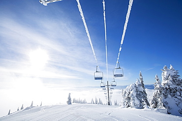 Ski lift at sunlight against blue ski, USA, Montana, Whitefish