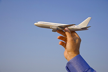 Man holding toy airplane