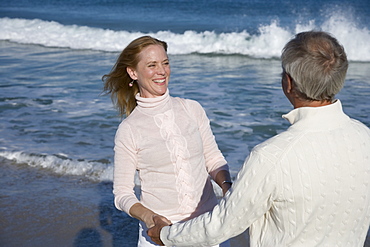 Couple holding hands at beach