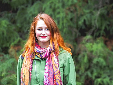 Portrait of smiling redhead in scarf and green jacket