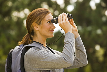 Woman looking through binoculars