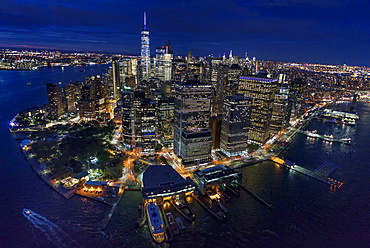 USA, New York, New York City, Manhattan, Aerial view of illuminated skyline with harbor at night