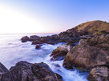 Australia, New South Wales, Port Macquarie, Lighthouse on rocky coat at sunrise