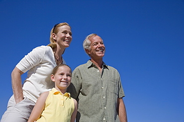 Low angle view of family under blue sky