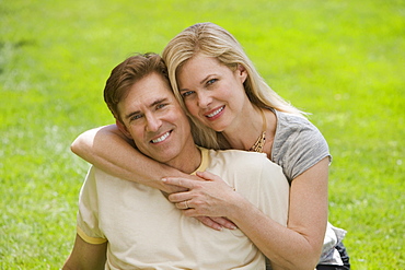 Couple hugging in grass