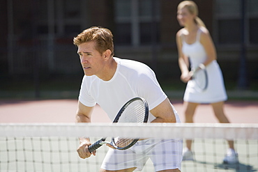 Couple playing tennis