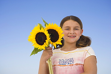 Girl holding sunflowers