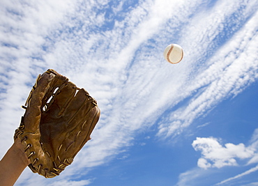 Hand in baseball glove catching ball