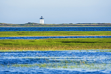 USA, Massachusetts, Cape Cod, Provincetown, Bay of water with lighthouse