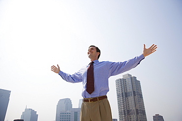 Businessman with arms outstretched