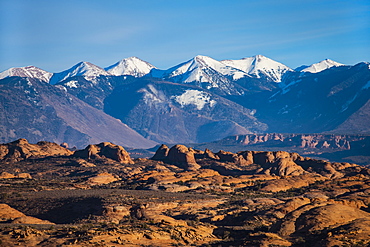 Snowcapped La Sal Mountains and sand dunes in Arches National Park, Utah, USA