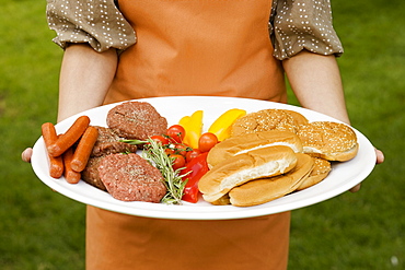 Person holding platter of food for barbeque