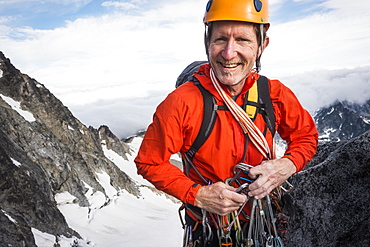 Mature man mountain climbing on Mount Stuart in North Cascade Mountains, Washington, USA