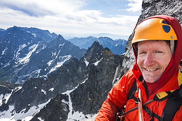 Mature man mountain climbing on Mount Stuart in North Cascade Mountains, Washington, USA