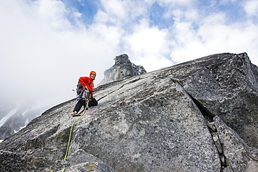 Mature man mountain climbing on Mount Stuart in North Cascade Mountains, Washington, USA