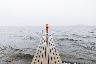 Young man on pier on Iceland