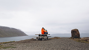 Couple sitting on picnic table