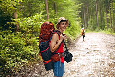 Young man hiking in forest at the Carpathian Mountain Range, Ukraine