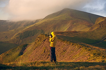 Man in yellow jacket taking photographs in the Carpathian Mountain Range