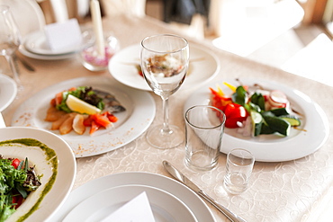 Drinking glasses and food on dining table during wedding