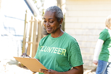 Mature woman volunteer with clipboard