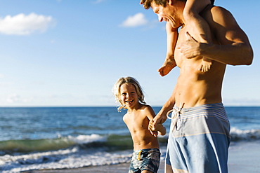 Man walking with his children on beach