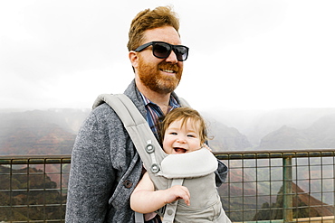 Father with his baby girl in baby carrier