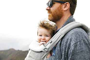 Father with his baby girl in baby carrier