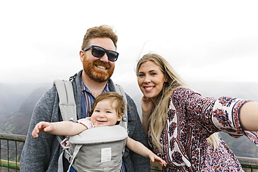 Parents with their baby girl in baby carrier