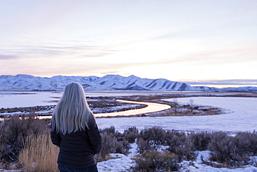 Mature woman by river during winter in Picabo, Idaho