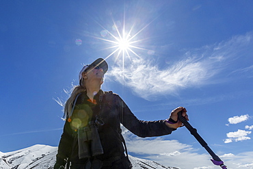 Low angle view of hiker on snow covered mountain