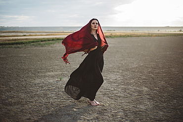 Windswept woman wearing red headscarf