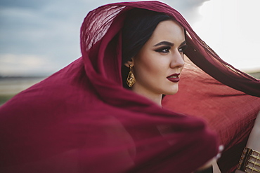 Windswept woman wearing red headscarf and lipstick