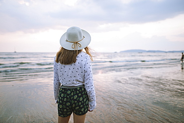 Young woman in sun hat on beach in Krabi, Thailand